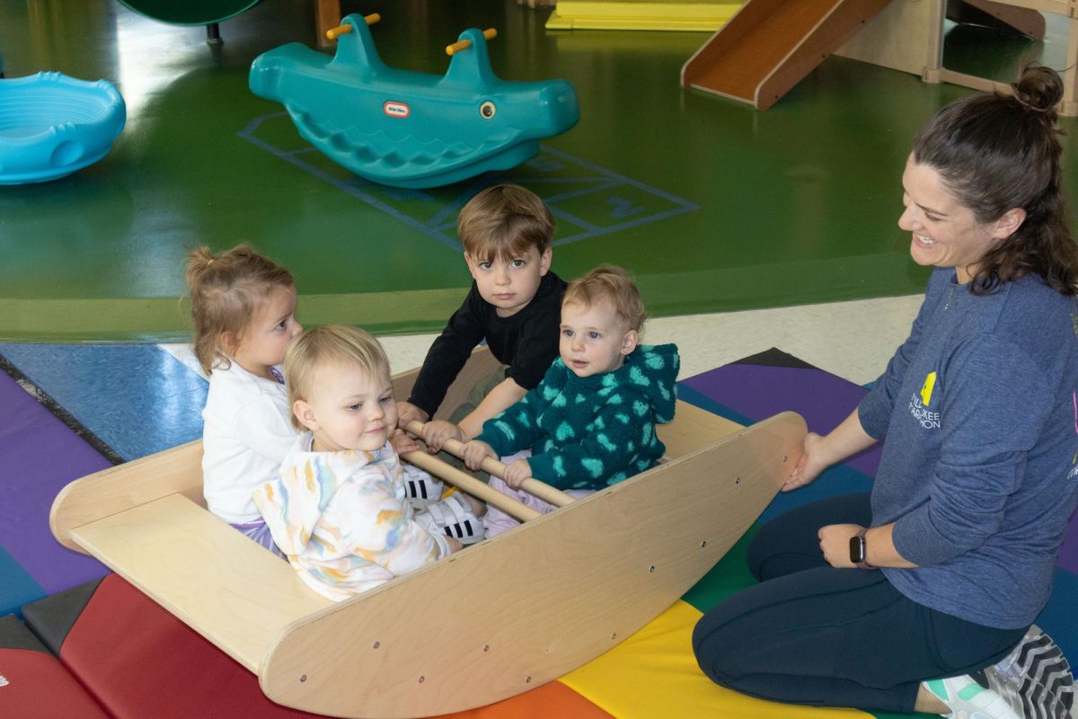 MATC Daycare children playing in wooden rocking boat on October 10, 2024.