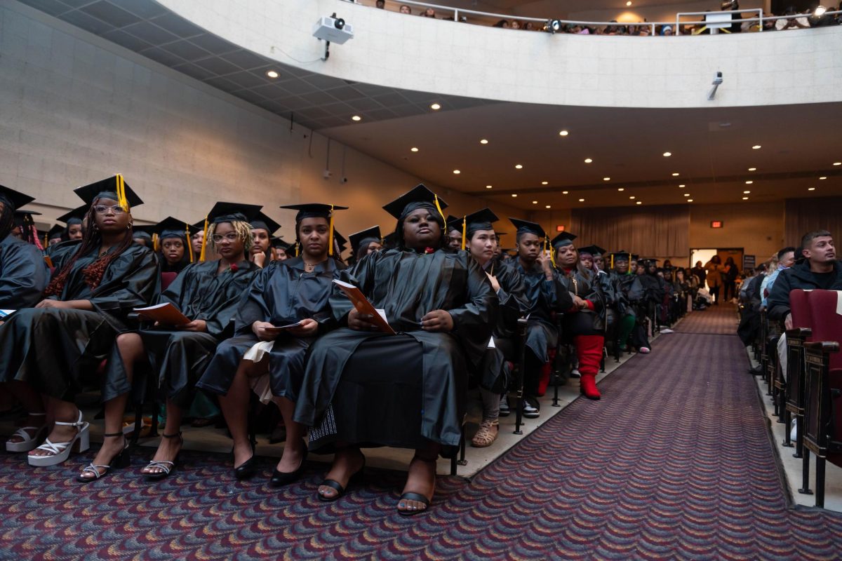 Students receiving GED/HSED diplomas sit in the Cooley Auditorium during a graduation ceremony on December 17.