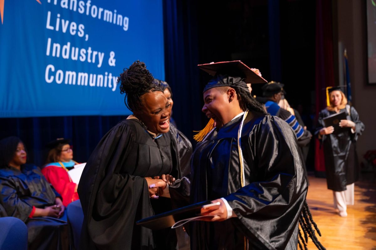 Happy graduates receiving their GED/HSED diplomas at a ceremony at MATC in December.