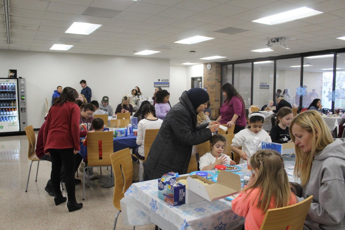 Tables full of family members decorating cookies in Oak Creek.