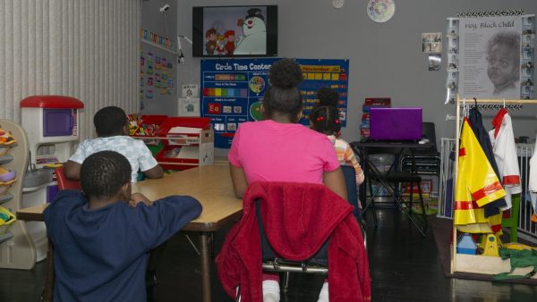 Children of the Encouraging Hearts and Minds Daycare watching Frosty the Snowman, a Christmas classic for children.