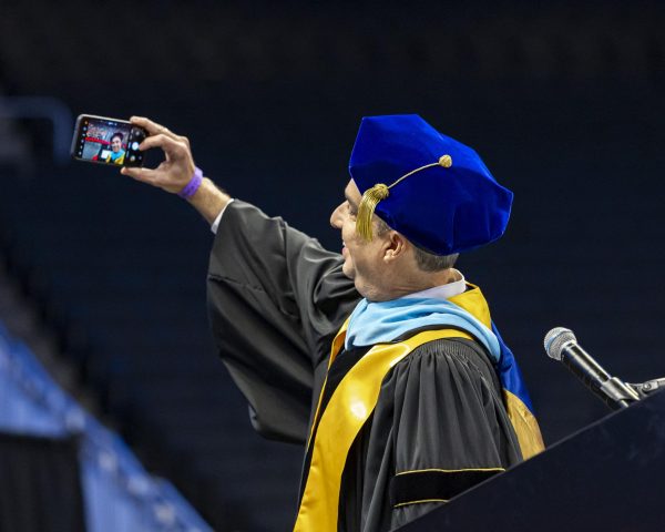 MATC President Dr. Anthony Cruz begins his speech by taking a selfie with the graduates and instructors in the crowd during MATC’s Winter Commencement, December 14, 2024. Milwaukee, WI