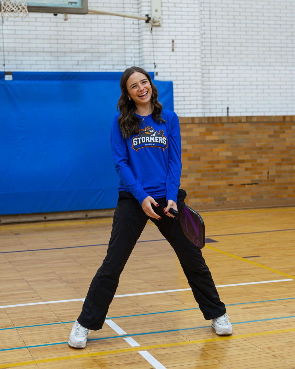 Freshman Outside Hitter, Teagan Cole laughing while playing pickleball with MATC President Dr. Anthony Cruz on January 30, 2025. 