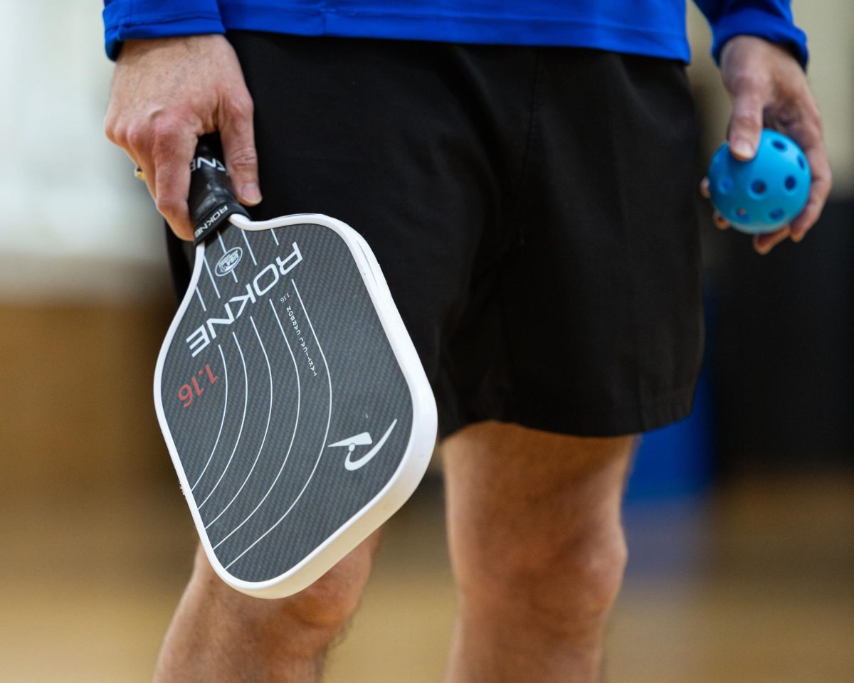 President Dr. Anthony Cruz gets ready to serve the ball during a game of pickleball in MATC’s Downtown Campus gymnasium. 