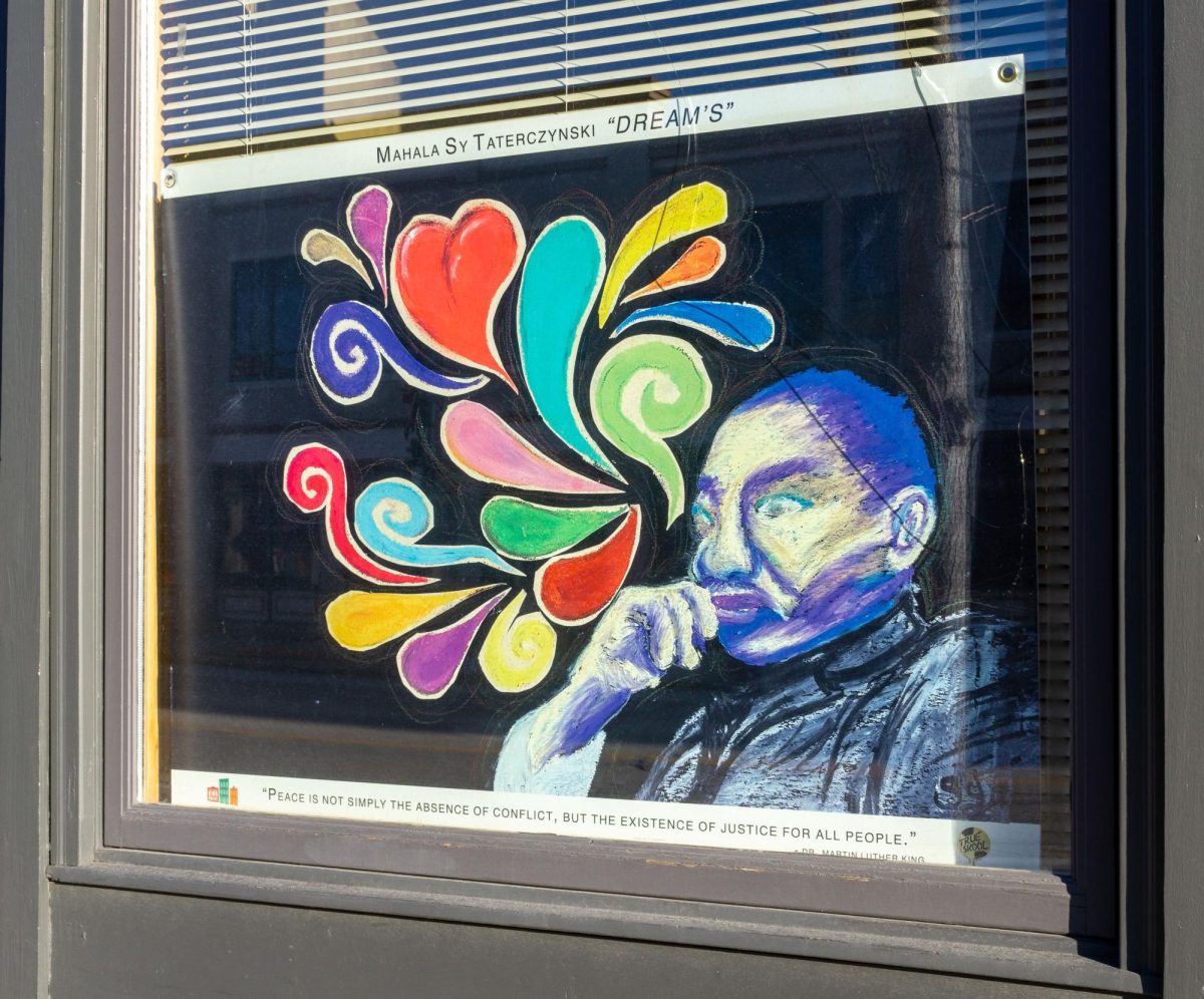 A portrait of Dr. Martin Luther King Jr. by Mahala Sy Taterczynski titled “Dreams” in the window of P3 Development Group, LLC. Located on 1916 N M.L.K. Dr, MIlwaukee WI, December 28,2024