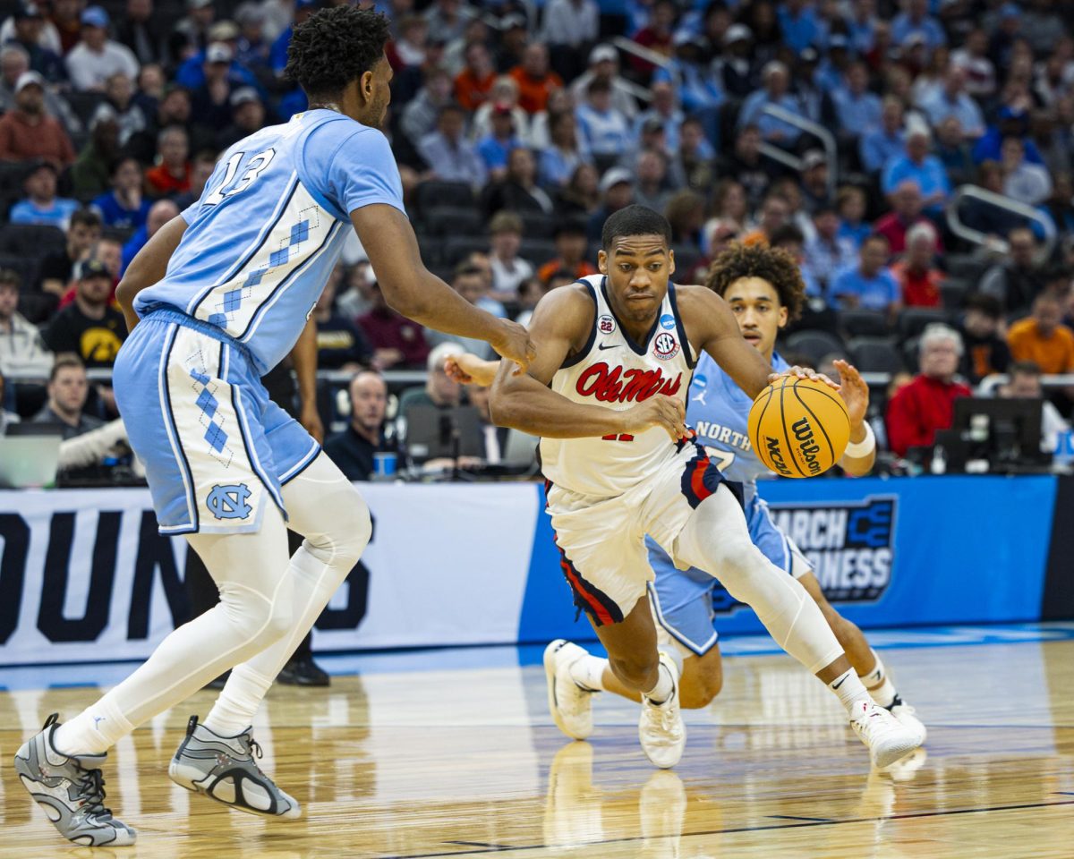 Ole Miss senior guard Mattew Murrell drives the ball in the lane against University of North Carolina (UNC) freshman guard Ian Jackson during NCAA Division I tournament play at Fiserv Forum in Milwaukee.