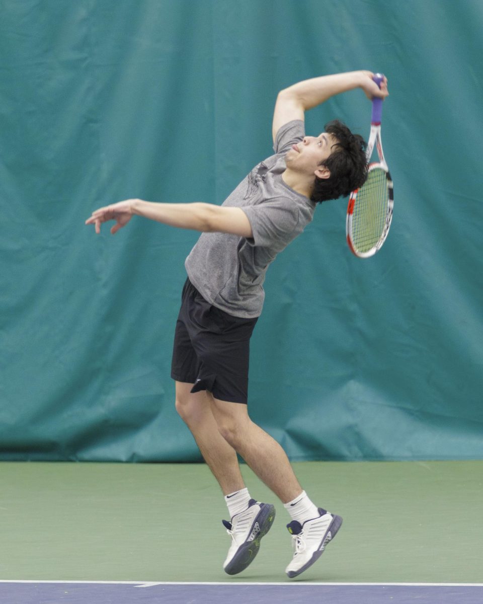 Stormers Tennis player Emiiano Carrion jumps to smash the ball in a match against McHenry County College. April 6, 2025 