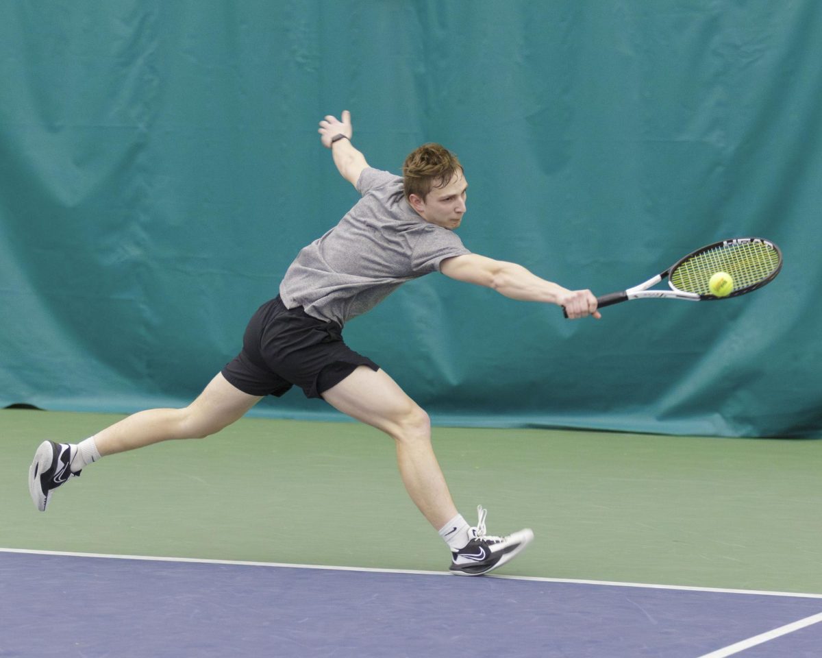 Stormers tennis player Ethan Ramsey reaches for the ball in a match against McHenry County College. April 6, 2025 