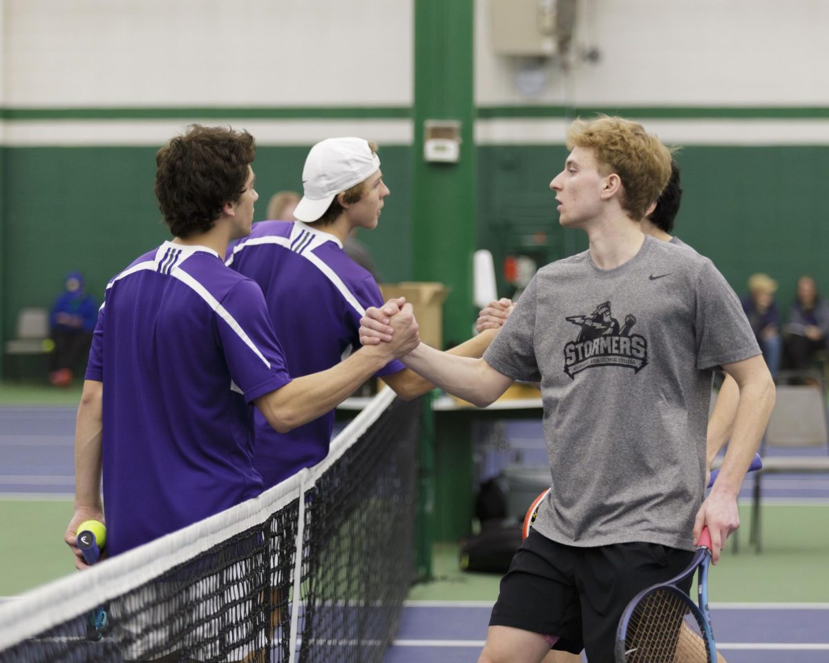Stormers tennis players Payton Kuzminski and Emiiano Carrion shake hands with opposing team McHenry County College. April 6, 2025
