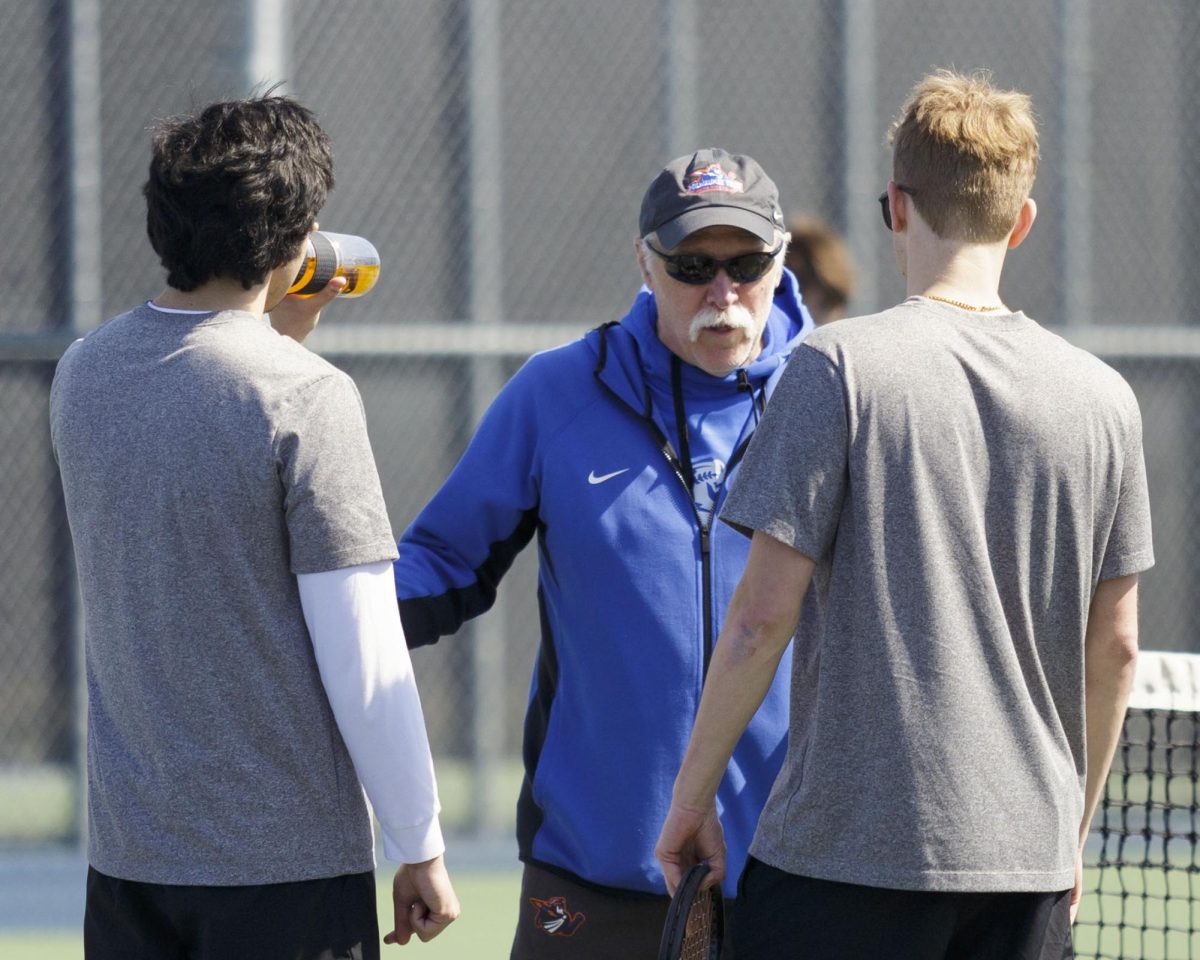 Coach Mark Picard has a brief huddle with a couple of men’s tennis players