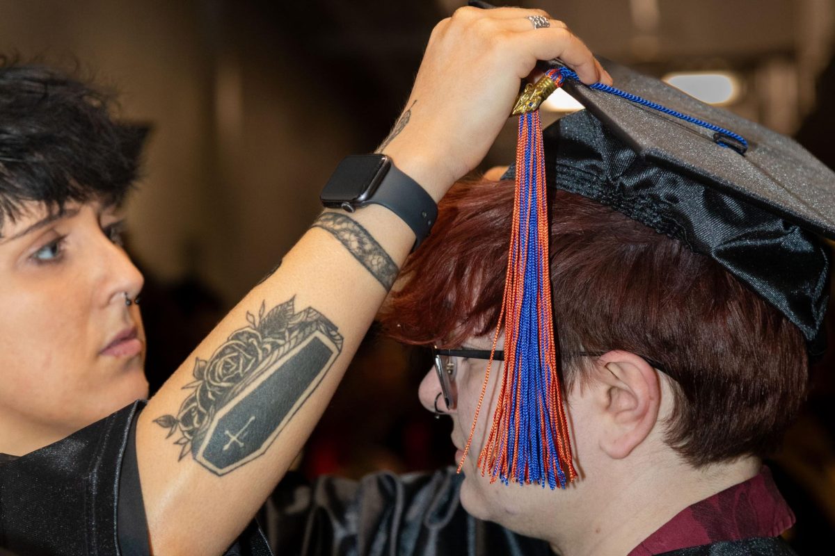 Final prepping takes place as a cap is straightened out before MATC's Spring Commencement on Saturday, May 17.
