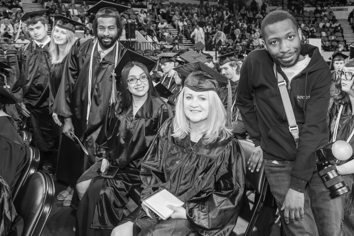 MATC Times Photographer, Daniel Ford (right) poses with a few graduates at the Spring 2025 Commencement ceremony.
