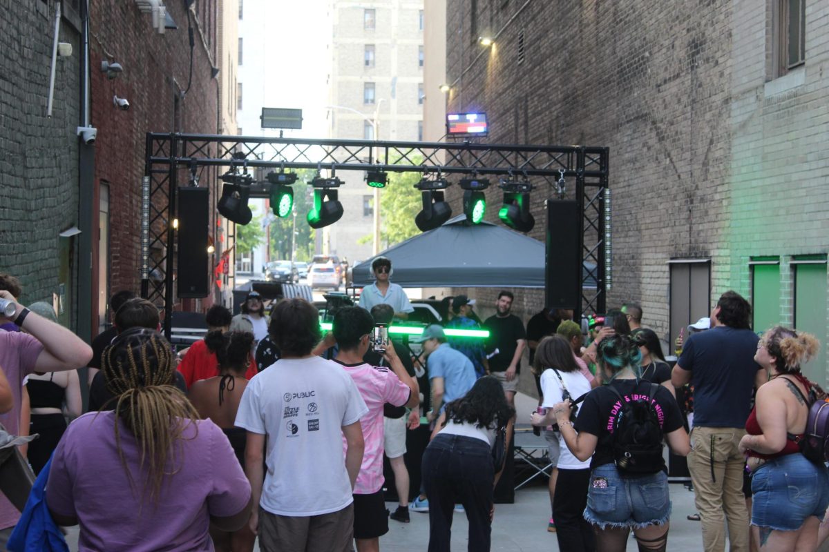 People gather for a performance at the Milwaukee Downtown Market on June 11.