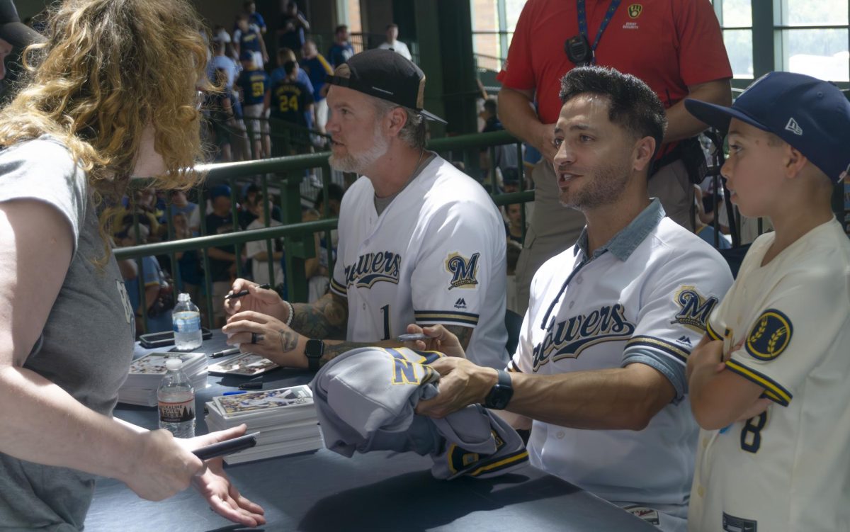 (pictured left to right) Brewers Corey Hart and Ryan Braun signed jerseys for fans before their 25th anniversary game on July 25, 2025.
