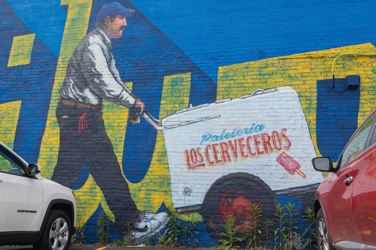 The paletero is pushing his cart of sweet frozen treats throughout the city in this mural at 415 S. 3rd St.