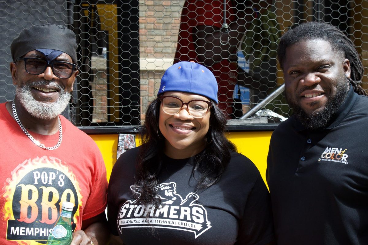 From left to right: Mike from Pop's BBQ, Student Life Coordinator Amanda Brooks and Dean of Student Experience, Equan Burrows pose in front of Pop's food truck at the Wild Out Wednesday Welcome Back party for students at the Downtown Campus on August 20.