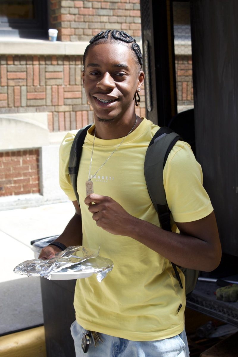 An MATC student is all smiles after eating his free meal at a Welcome Back event.