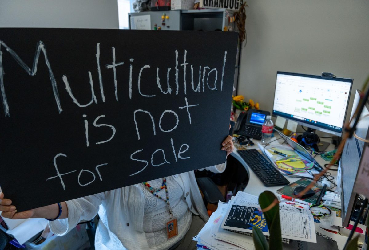Tanya Torres of the Multicultural Services office holding a sign that reads “Multicultural is not for sale” in support of students' silent protest. August 26, 2025. 