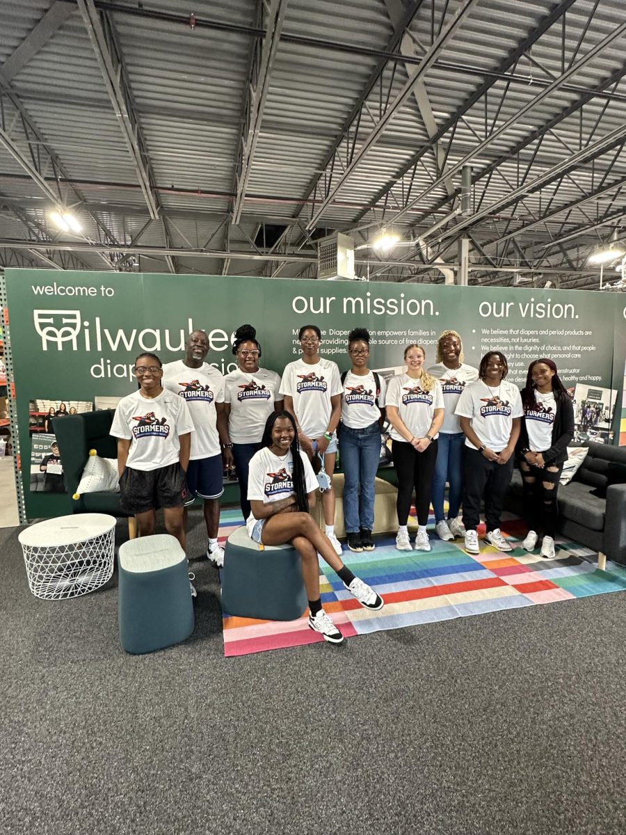 Members of the Stormers women's basketball team pose for a photo in a Cudahy warehouse after volunteering at the Milwaukee Diaper Mission. Photo shared by MATC Athletics.