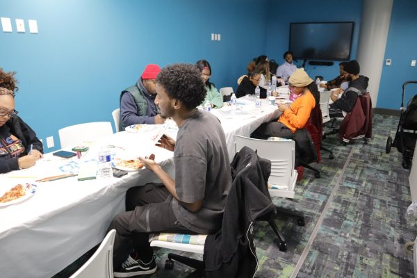 Students, staff, and children gather to create at BSU's Paint & Sip event in room S305 on November 20, 2025.