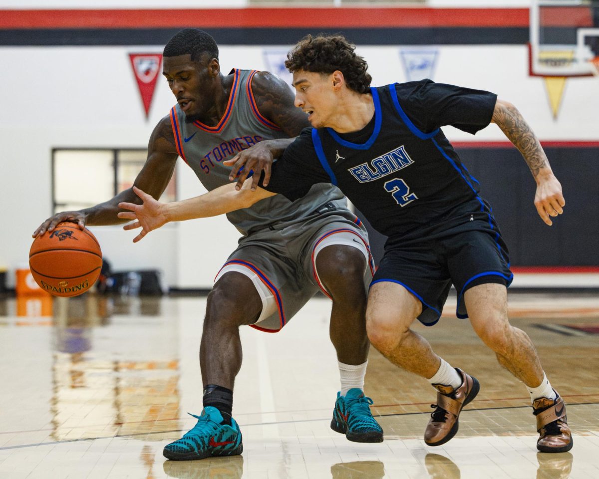 Sophomore point guard Qi’Andre Washington shields the ball from his defender in the home opener win (131-76) against Elgin Community College on November 13, 2025. 