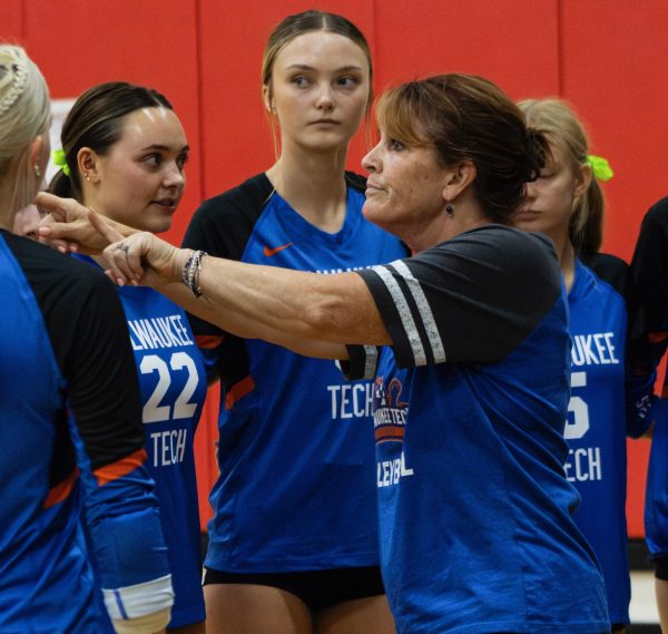Coach Shel DeLisle instructs women's volleyball players during a timeout.