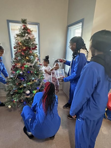 Stormers women’s basketball players help children decorate a Christmas tree at Hope House. Photo provided by the Athletics Department.