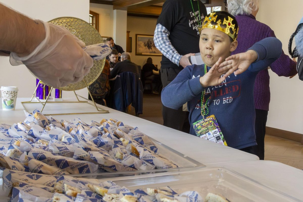 A young guest can’t hide his excitement at the Wisconsin Bakers Association Paczki Party and Mardi Gras Dessert Tasting Experience in Franklin, WI.