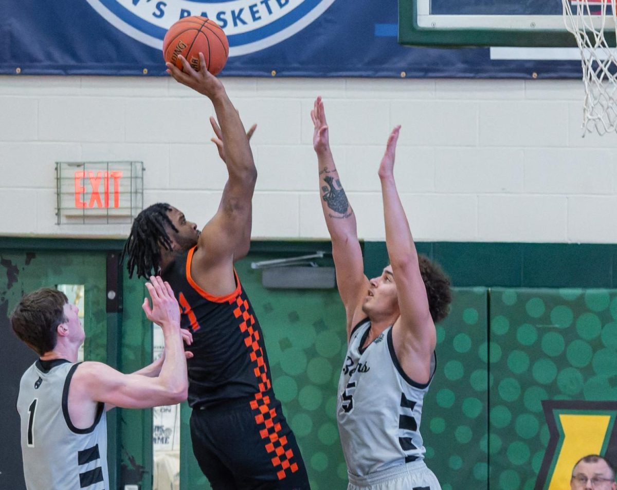 Stormers #21 Turon Rivers shooting into the basket with two defenders trying to block him during Friday's consolation game. Photo provided by NJCAA.
