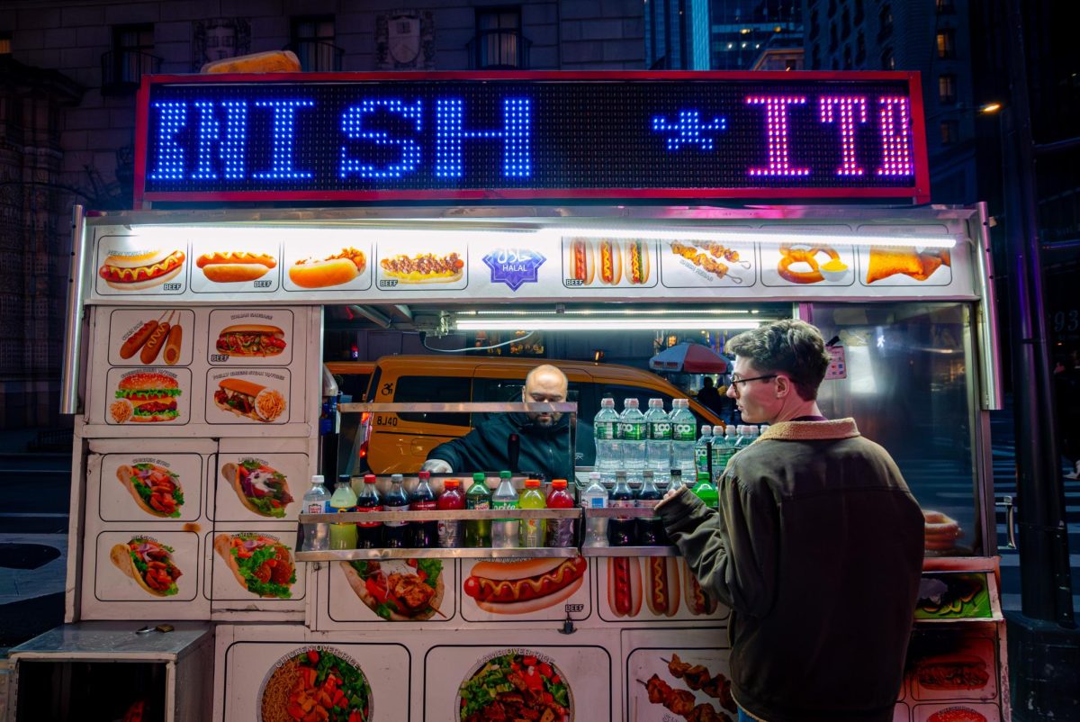 MATC Times News Editor Connor Servais waits for food he's ordered from a street vendor. He 'haggled' over the price, when he got his order which is something he wanted to do while in New York.