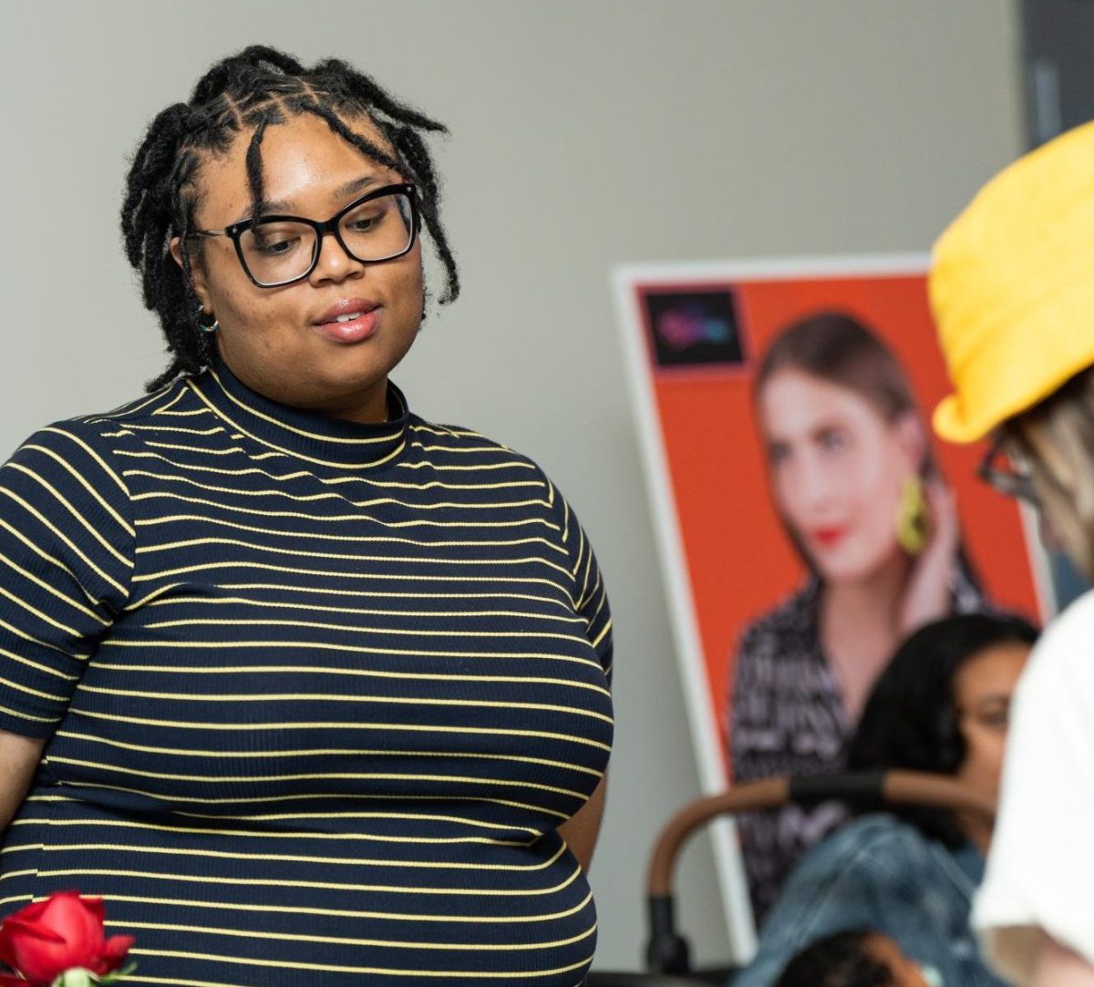 Photography graduate Cierra Pleshette Wilson hands out freebies at gallery night.