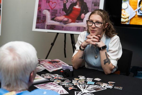 Elizabeth Kamprath, a photography graduate, engages with a guest.