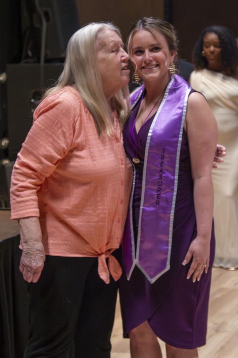 Dental Hygiene program graduate poses with family member