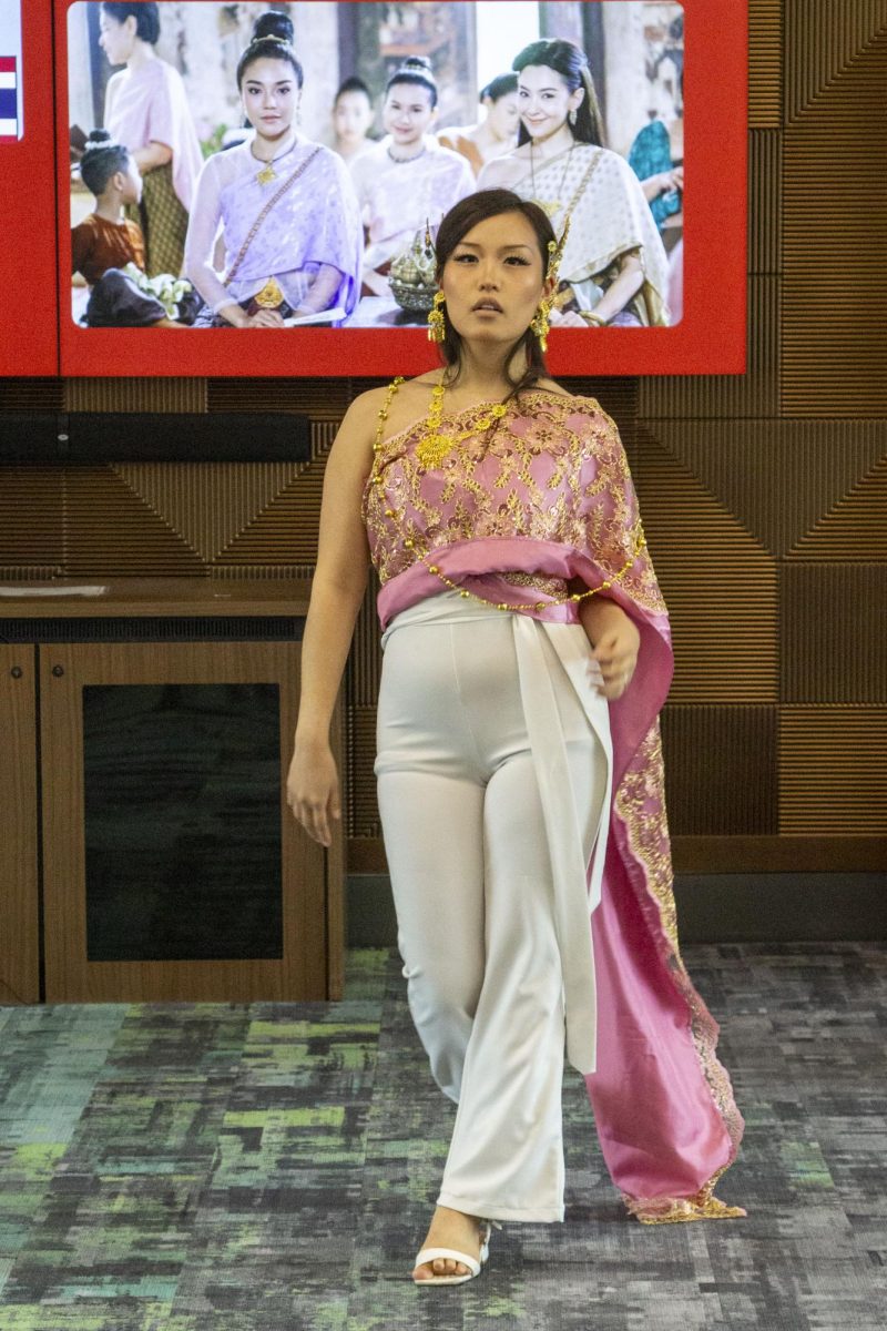 Model struts on the runway wearing traditional attire at the Flavors, Fabrics, and Facts event, May 6, 2026.