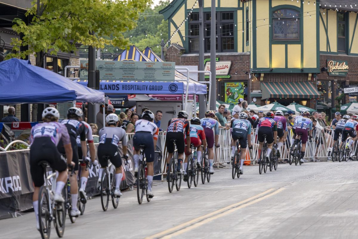 A group of cyclists make their way through the Wauwatosa Village 