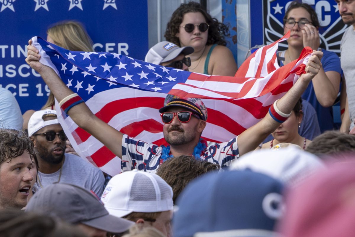 Spectator waives his flag in support of the US Men's National soccer team 