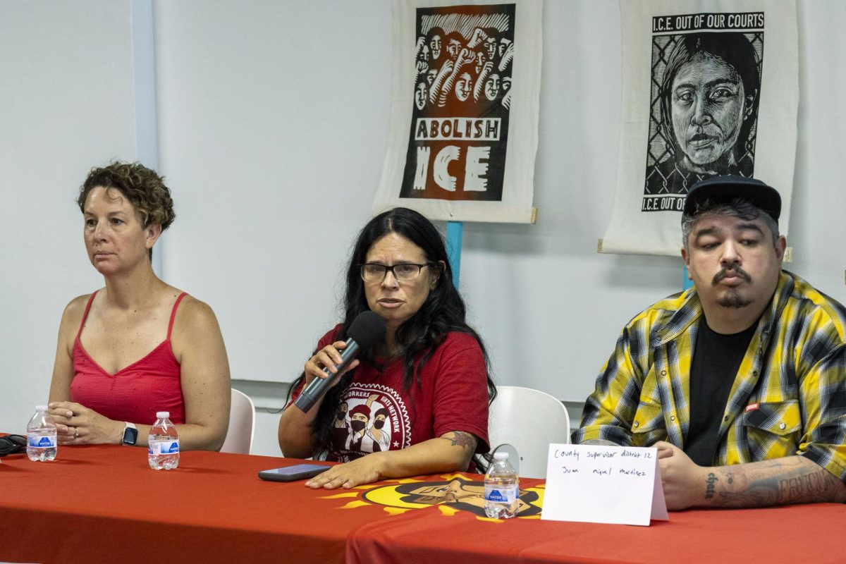Voces De La Frontera staffer addresses the media alongside Milwaukee Alderwoman Marina Dimitrijevic (left) and Milwaukee County Supervisor Juan Miguel Martinez (right).